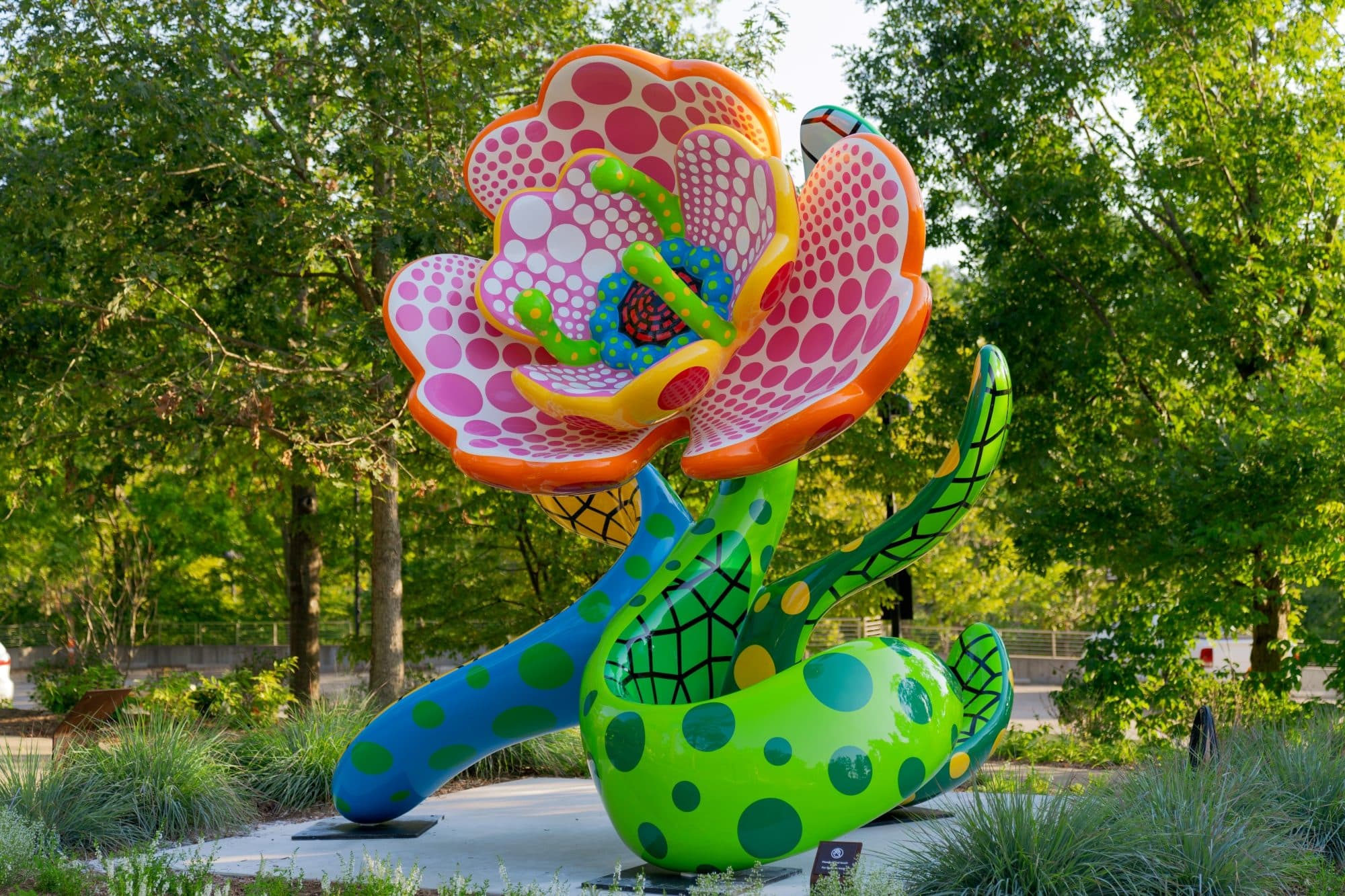Yayoi Kusama, I Spend Each Day Embracing Flowers, 2023, stainless steel and urethane paint. Private collection.