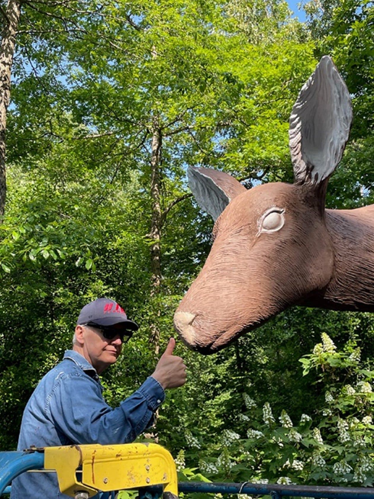 Tony Tasset giving a “thumbs up” with Deer during the painting process.